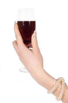 Woman hand with pearl bracelet holding wineglass on white