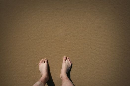 Lonesome feet on a remote beach