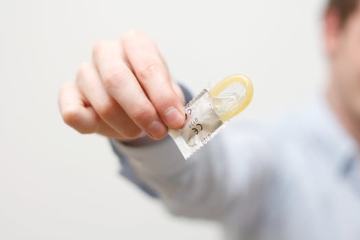 A man showing a condom