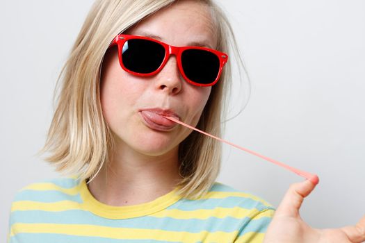 A girl playing with her chewing gum