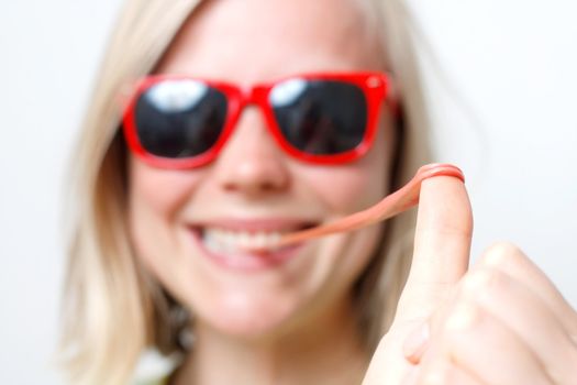 A girl playing with her chewing gum