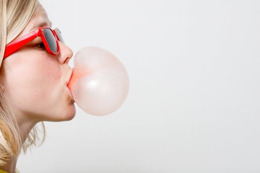 A girl playing with her chewing gum