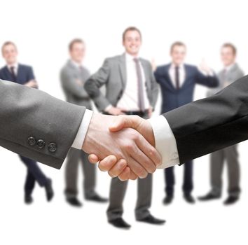 Businessmen in a group and a handshake