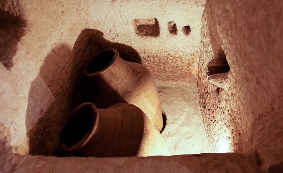 A horizontal shot of a bath tub dating back roman times, man made in a limestone cave once occupied by humans, crop space, copy area, sepia look