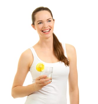 Isolated portrait of a young beautiful laughing woman holding a glass of water with slice of lemon.