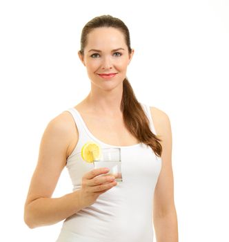 Young beautiful smilingwoman holding a glass of water with slice of lemon. Isolated over white.