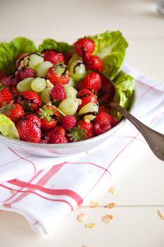 Delicious fruit salad with strawberries, grapes and raspberries