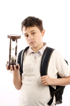 Portrait of a schoolboy with hour-glass. Time to school concept 