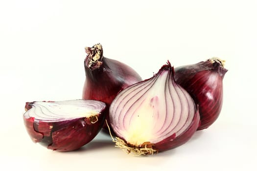 three red onions on a white background