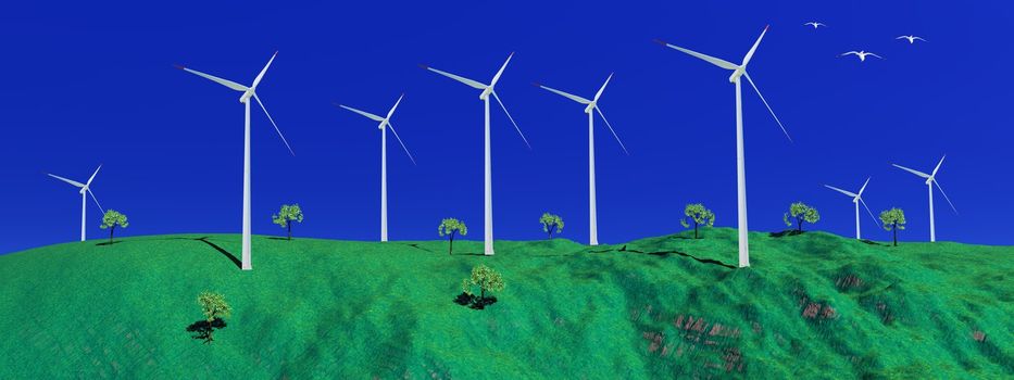 Birds flying next to wind turbines at the top of a green hill with small trees