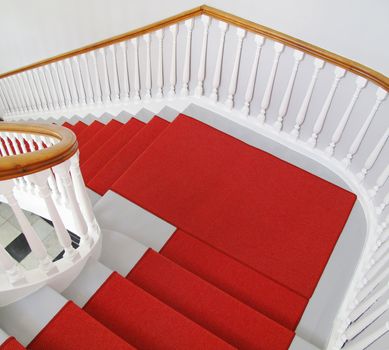 Nice old staircase with red carpet.