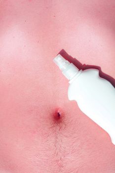 Sunscreen and a male body