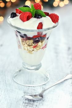Healthy yogurt parfait with fresh fruit and mint.

