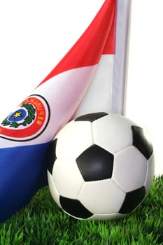 Flag of Paraguay with a football in a field