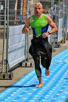 GENEVA, SWITZERLAND - JULY 24 : one unidentified male runner after the swimm race at the international Geneva Triathlon, on july 24, 2011 in Geneva, Switzerland