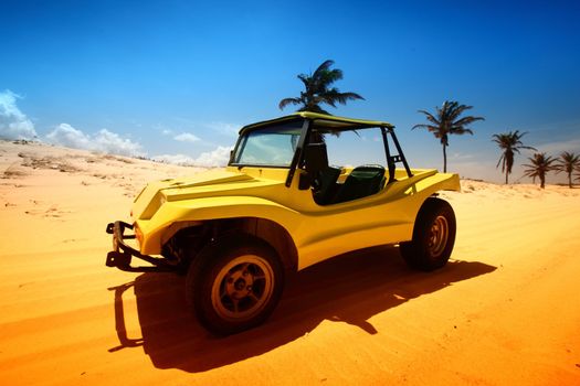 desert buggy in desert sand under blue sky