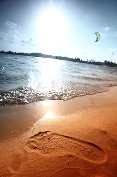 ocean footprints on sand near water