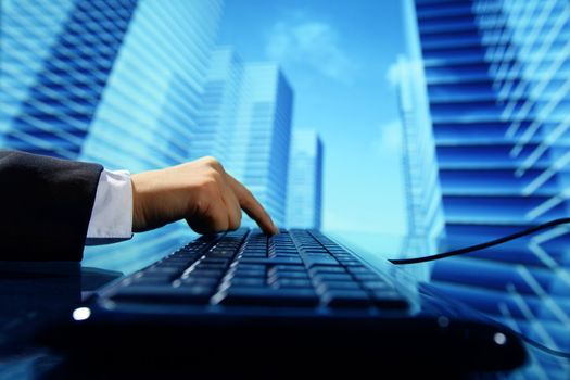 reseller work on keyboard skyscrapers on background