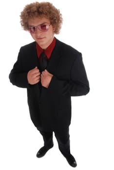 Young businessman standing in a black suit on white
