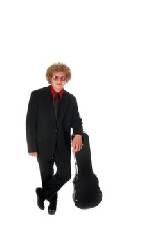 Guitar Player in a suit leans on a guitar case.