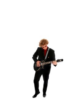 Young man in a black suite playing guitar
