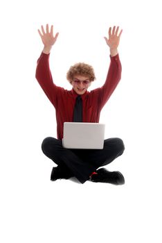 Young businessman looking at a laptop, arms in the air
