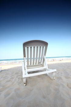 chair on sand and ocean background