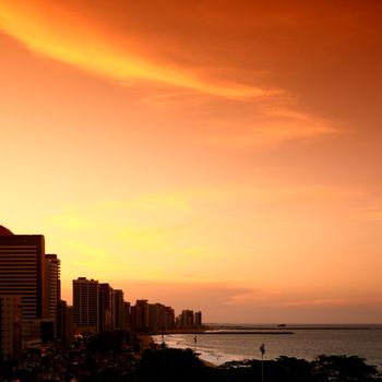 city sunset on ocean water