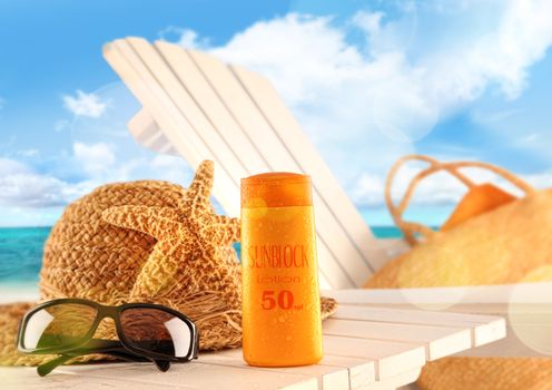 Sunblock lotion and accessories on table at the beach