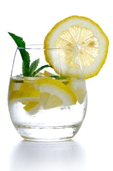 Glass of fresh cool drink with lime fruits isolated on white background.