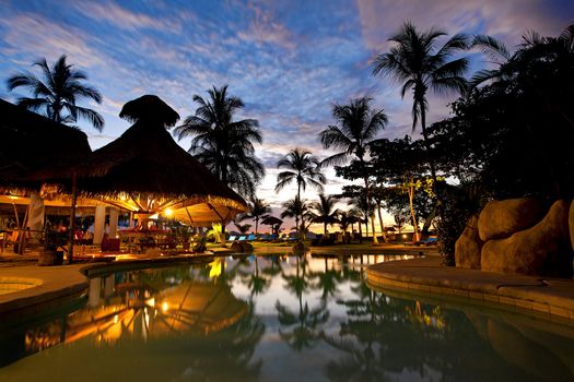 Evening picture of the swimming pool area on a resort