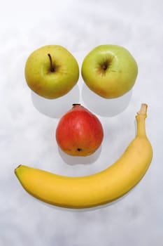 nice fruit face with banana, apples and pear