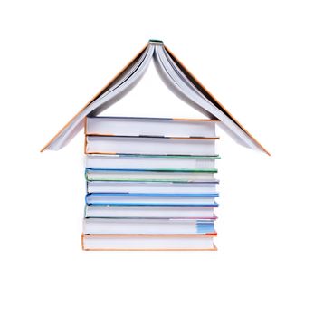 House made from few new books on white background