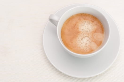 Espresso Coffee in White Cup on Light Tablecloth