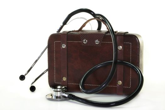 Stethoscope and suitcase on a white background