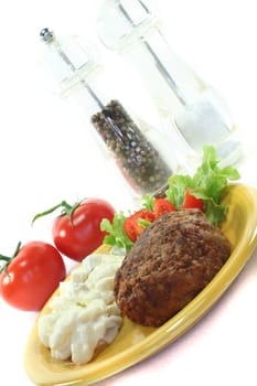 Meatball with potato salad, fresh lettuce and tomato pieces