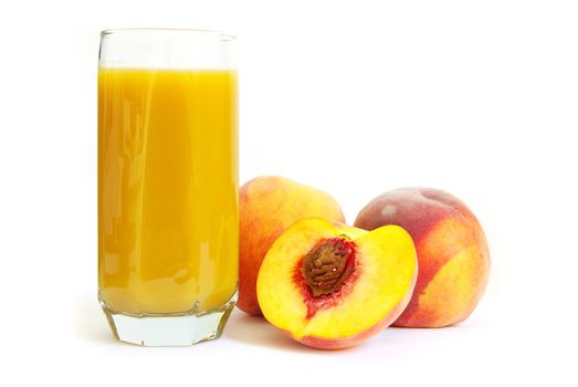 Glass with freshly made peach juice on a white background