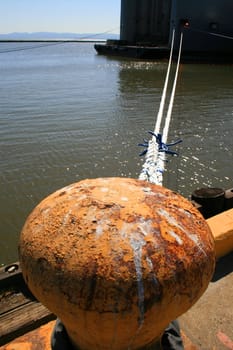 Close up of an old and rusty seaport anchor.
