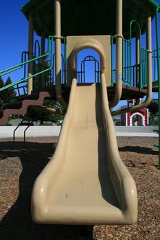 Slide in a school playground in summer.
