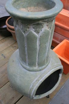 Close up of a gray garden fireplace.
