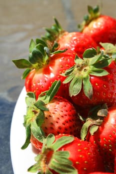 Close up of the strawberries on a plate.
