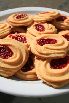 Close up of sweet strawberry shortbread cookies on a plate.