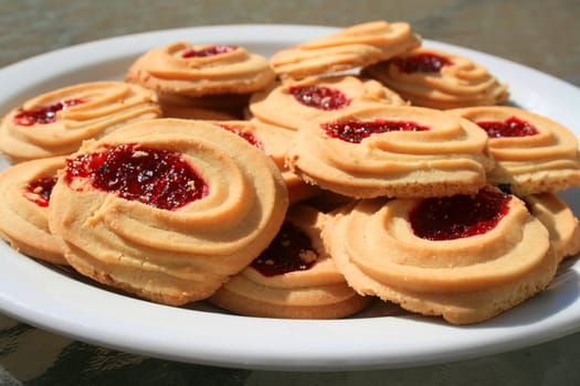 Close up of sweet strawberry shortbread cookies on a plate.