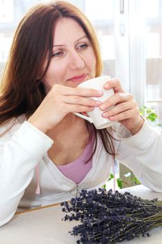 Mature woman relaxing at home holding a cup