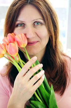 Smiling mature woman holding bouquet of flowers