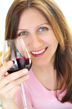 Smiling mature woman holding a glass of red wine