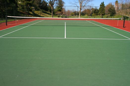 Tennis court during day time in a park.
