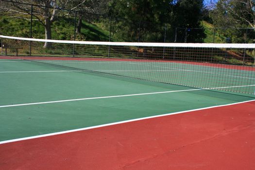 Tennis court during day time in a park.