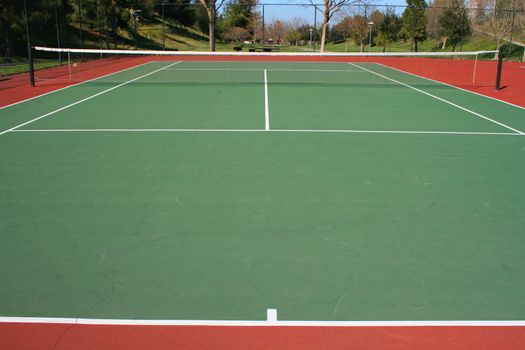 Tennis court during day time in a park.