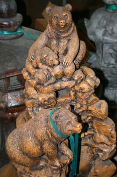 Close up of a statue of three bears.
